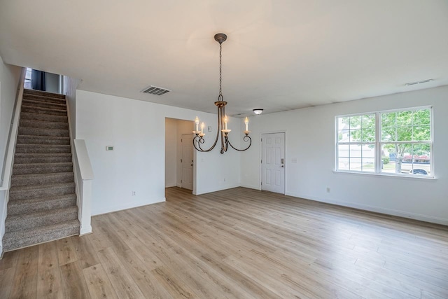 811 S Edisto River Dr, Roebuck, SC 29376 - unfurnished dining area featuring a chandelier, stairs, and light wood finished floors
