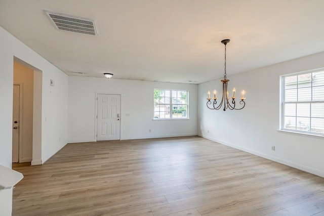 811 S Edisto River Dr, Roebuck, SC 29376 - empty room with light wood-style flooring and a chandelier