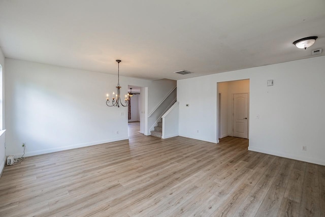 811 S Edisto River Dr, Roebuck, SC 29376 - unfurnished room featuring stairs, a chandelier, and light wood-type flooring