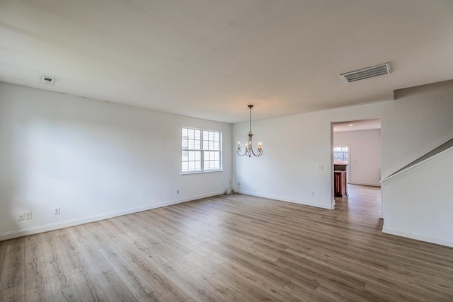 811 S Edisto River Dr, Roebuck, SC 29376 - spare room featuring a chandelier, plenty of natural light, and wood finished floors