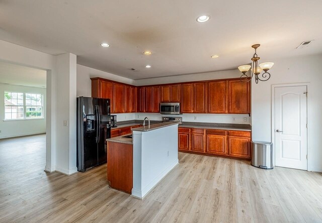 811 S Edisto River Dr, Roebuck, SC 29376 - kitchen with appliances with stainless steel finishes, light wood-type flooring, dark countertops, a chandelier, and recessed lighting
