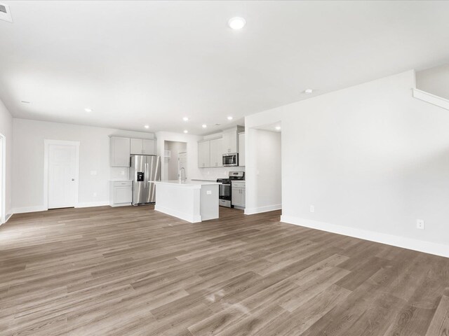 791 Burghley Cir, Greer, SC 29651 - unfurnished living room with recessed lighting and light wood finished floors