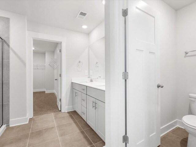 791 Burghley Cir, Greer, SC 29651 - bathroom featuring a shower stall, double vanity, tile patterned floors, a walk in closet, and recessed lighting