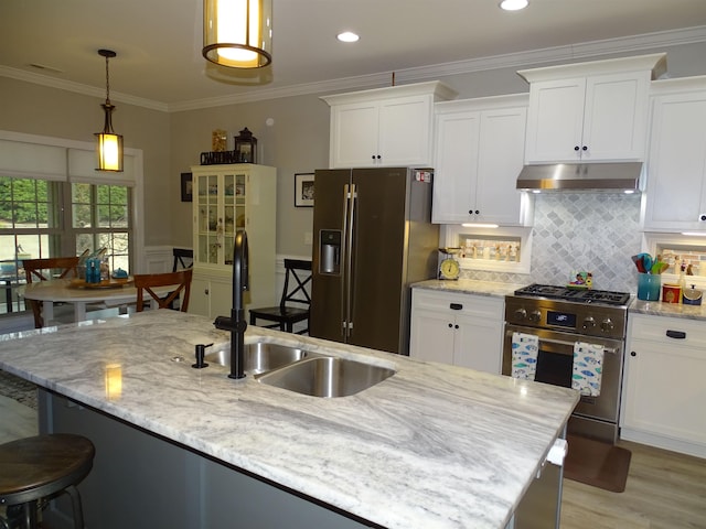 811 White Magnolia Dr, Inman, SC 29349 - kitchen featuring appliances with stainless steel finishes, under cabinet range hood, white cabinets, tasteful backsplash, and crown molding