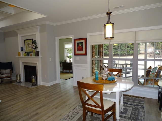 811 White Magnolia Dr, Inman, SC 29349 - dining room with wood finished floors, ornamental molding, and a fireplace with flush hearth