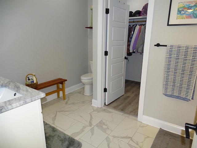 811 White Magnolia Dr, Inman, SC 29349 - bathroom featuring vanity, marble look tiles, and a walk in closet