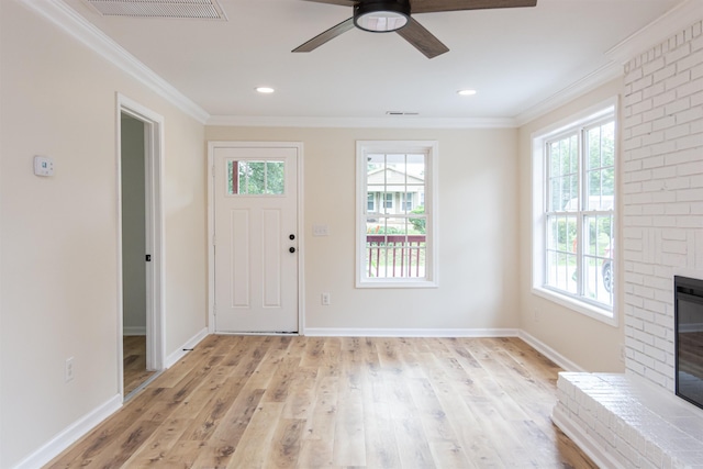 1230 Edgewood Ave, Spartanburg, SC 29301 - entrance foyer featuring plenty of natural light, a fireplace, light wood finished floors, ceiling fan, and crown molding