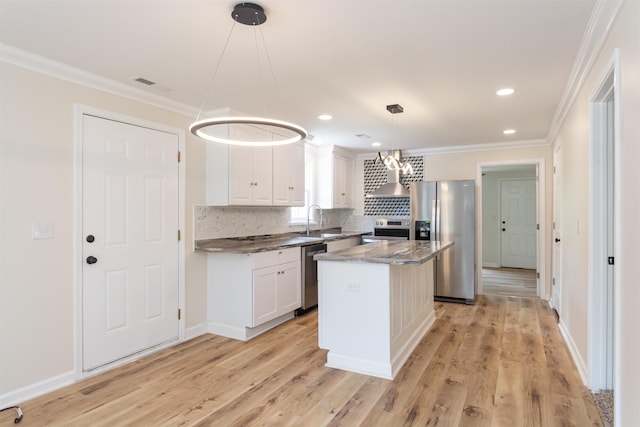 1230 Edgewood Ave, Spartanburg, SC 29301 - kitchen with stainless steel appliances, wall chimney exhaust hood, crown molding, white cabinets, and tasteful backsplash