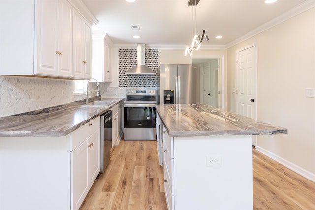 1230 Edgewood Ave, Spartanburg, SC 29301 - kitchen with appliances with stainless steel finishes, wall chimney exhaust hood, crown molding, a center island, and light wood-style flooring
