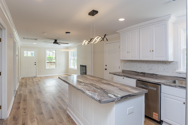 1230 Edgewood Ave, Spartanburg, SC 29301 - kitchen with dishwasher, ornamental molding, a center island, a fireplace, and a ceiling fan