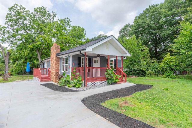 1230 Edgewood Ave, Spartanburg, SC 29301 - view of front of house with a porch, a front yard, ceiling fan, concrete driveway, and a chimney