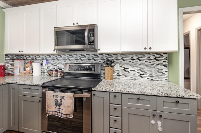 101 Jordan Rd, Lyman, SC 29365 - kitchen with stainless steel appliances, gray cabinetry, decorative backsplash, and light stone countertops