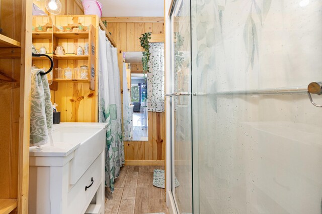 101 Jordan Rd, Lyman, SC 29365 - bathroom with wooden walls, a shower stall, wood finished floors, and vanity