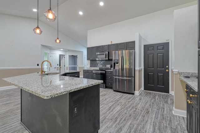 203 Palmetto Dr, Greer, SC 29651 - kitchen with stainless steel appliances, light wood-type flooring, high vaulted ceiling, a large island with sink, and tasteful backsplash