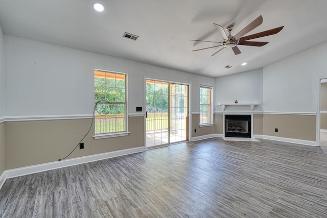 203 Palmetto Dr, Greer, SC 29651 - unfurnished living room with a ceiling fan, wood finished floors, a fireplace with flush hearth, recessed lighting, and vaulted ceiling