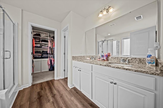 9035 Germaine Ct, Boiling Springs, SC 29316 - bathroom with a stall shower, a spacious closet, double vanity, and wood finished floors