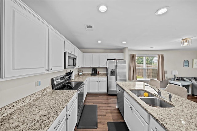 9035 Germaine Ct, Boiling Springs, SC 29316 - kitchen with appliances with stainless steel finishes, white cabinets, dark wood-type flooring, open floor plan, and recessed lighting