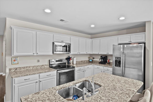 9035 Germaine Ct, Boiling Springs, SC 29316 - kitchen with appliances with stainless steel finishes, white cabinets, light stone countertops, and recessed lighting