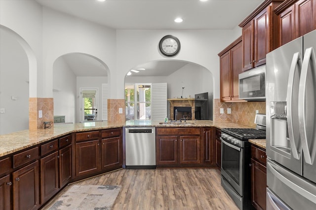 505 E Czardas Way, Woodruff, SC 29375 - kitchen with stainless steel appliances, light wood-type flooring, recessed lighting, backsplash, and light stone counters