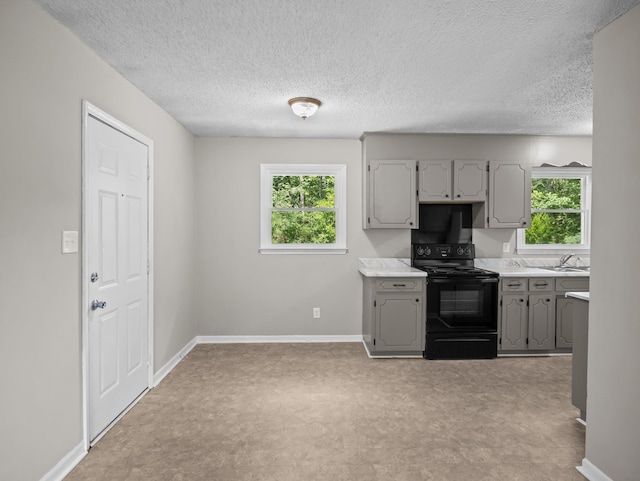 126 Loblolly Dr, Wellford, SC 29385 - kitchen featuring electric range, gray cabinets, plenty of natural light, light countertops, and a textured ceiling