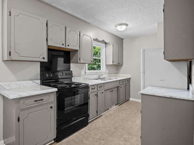 126 Loblolly Dr, Wellford, SC 29385 - kitchen with black electric range oven, a textured ceiling, gray cabinets, light countertops, and light flooring