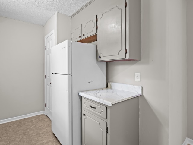 126 Loblolly Dr, Wellford, SC 29385 - kitchen with freestanding refrigerator, a textured ceiling, and light countertops