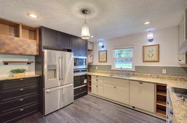 120 Branch St, Campobello, SC 29322 - kitchen with appliances with stainless steel finishes, dark wood-style floors, a textured ceiling, backsplash, and light stone counters