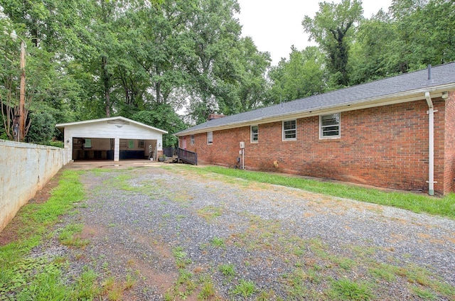 120 Branch St, Campobello, SC 29322 - view of property exterior featuring brick siding, driveway, a chimney, a carport, and a shingled roof