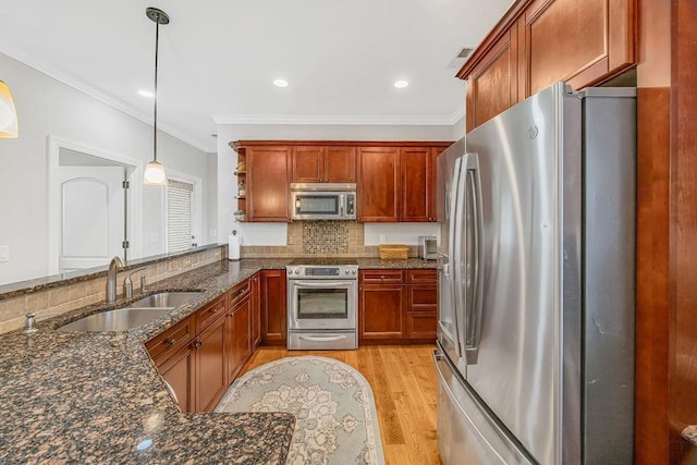325 Reflection Dr, Lyman, SC 29365 - kitchen featuring stainless steel appliances, light wood-style floors, ornamental molding, decorative light fixtures, and dark stone countertops