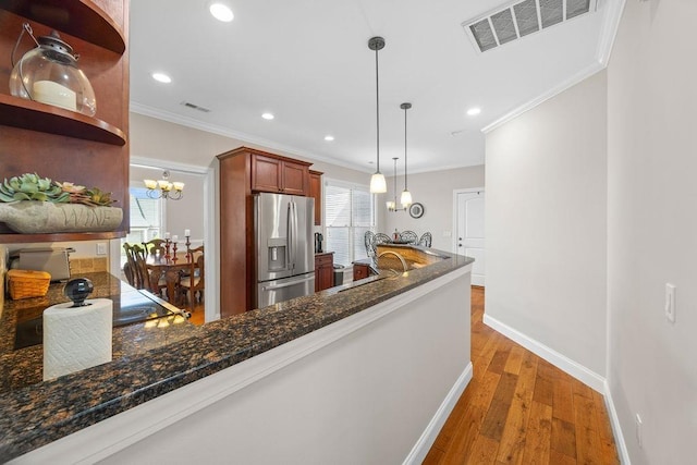 325 Reflection Dr, Lyman, SC 29365 - kitchen with stainless steel refrigerator with ice dispenser, open shelves, ornamental molding, wood finished floors, and plenty of natural light