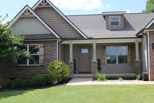 4921 Parris Bridge Rd, Boiling Springs, SC 29316 - craftsman house featuring stone siding, a front lawn, covered porch, and roof with shingles