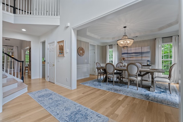 5 Modesto Ln, Simpsonville, SC 29681 - dining area with healthy amount of natural light, stairway, a chandelier, crown molding, and wainscoting