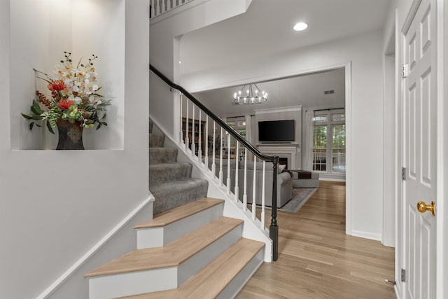 5 Modesto Ln, Simpsonville, SC 29681 - stairs with wood finished floors, a chandelier, and recessed lighting