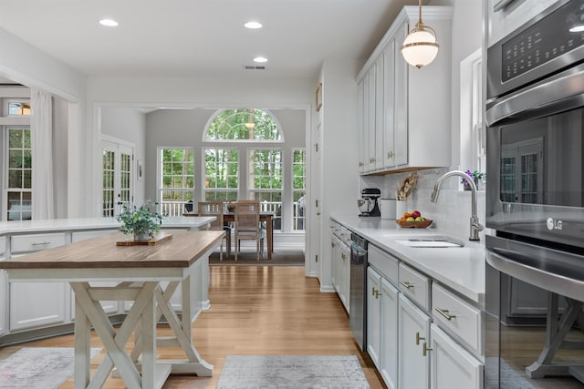 5 Modesto Ln, Simpsonville, SC 29681 - kitchen featuring stainless steel appliances, wooden counters, backsplash, light wood-type flooring, and recessed lighting