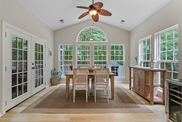 5 Modesto Ln, Simpsonville, SC 29681 - dining room featuring beverage cooler, french doors, light wood-style floors, a ceiling fan, and vaulted ceiling