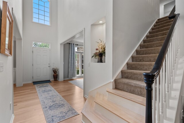 5 Modesto Ln, Simpsonville, SC 29681 - entryway with plenty of natural light, stairway, a towering ceiling, and wood finished floors