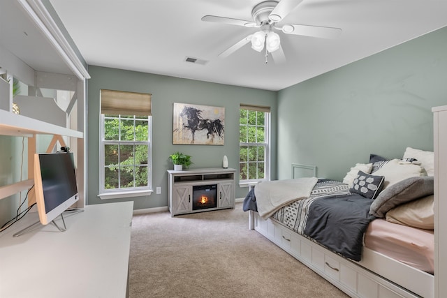 5 Modesto Ln, Simpsonville, SC 29681 - bedroom featuring light carpet, a glass covered fireplace, and ceiling fan