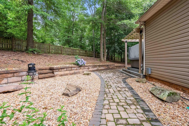 5 Modesto Ln, Simpsonville, SC 29681 - fenced backyard with a patio area, a pergola, and view of wooded area