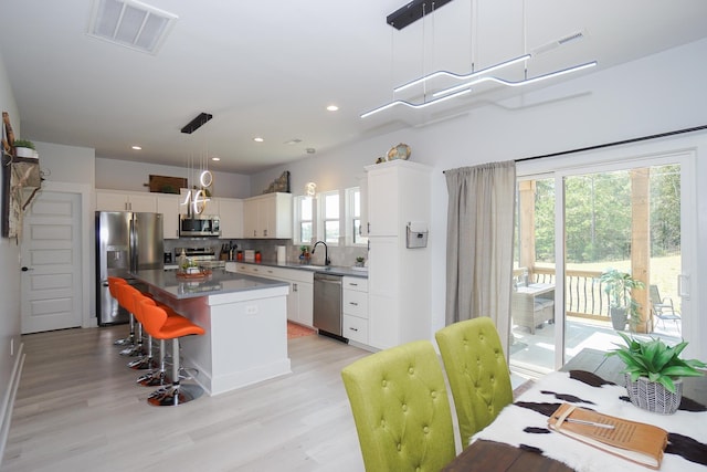 125 Patton St, Fountain Inn, SC 29644 - kitchen with stainless steel appliances, plenty of natural light, decorative backsplash, a kitchen island, and recessed lighting