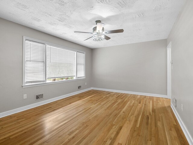 177 Continental Dr, Spartanburg, SC 29302 - spare room featuring light wood-style floors, a textured ceiling, and ceiling fan
