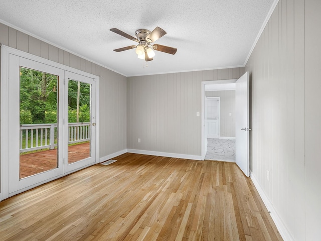 177 Continental Dr, Spartanburg, SC 29302 - unfurnished room featuring crown molding, light wood-type flooring, a ceiling fan, a textured ceiling, and wooden walls