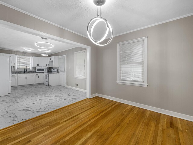 177 Continental Dr, Spartanburg, SC 29302 - unfurnished living room with ornamental molding and light marble finish flooring