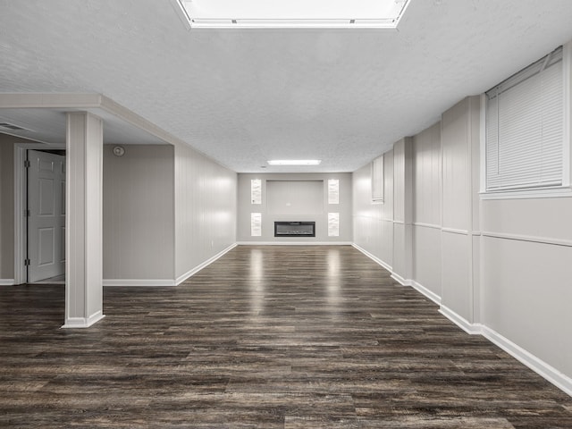 177 Continental Dr, Spartanburg, SC 29302 - unfurnished living room featuring wood finished floors, a textured ceiling, and a glass covered fireplace