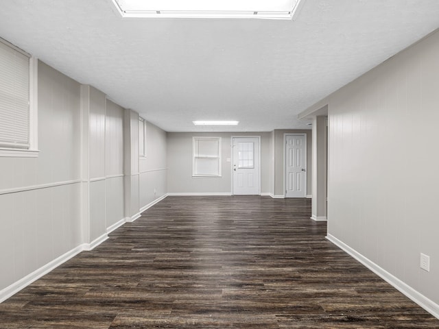 177 Continental Dr, Spartanburg, SC 29302 - spare room featuring dark wood-style flooring, a textured ceiling, and a decorative wall