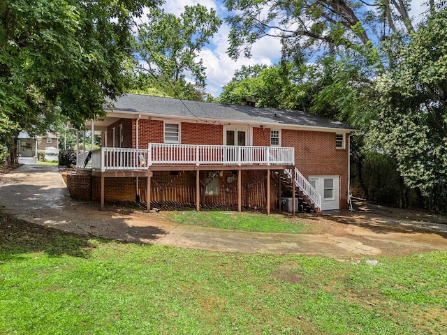 177 Continental Dr, Spartanburg, SC 29302 - back of property with stairs, brick siding, a wooden deck, and a yard