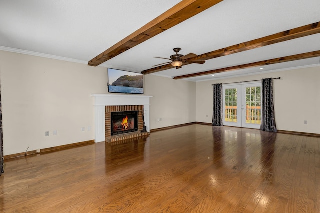 21 Glen Eagle Pl, Spartanburg, SC 29301 - unfurnished living room featuring a brick fireplace, beamed ceiling, ceiling fan, wood finished floors, and french doors