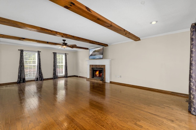 21 Glen Eagle Pl, Spartanburg, SC 29301 - unfurnished living room with a brick fireplace, beam ceiling, ceiling fan, wood finished floors, and crown molding