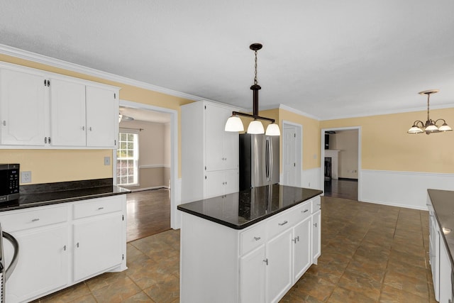 21 Glen Eagle Pl, Spartanburg, SC 29301 - kitchen featuring freestanding refrigerator, dark countertops, crown molding, a center island, and white cabinetry