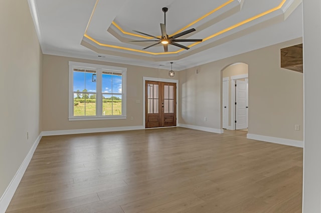 11555 New Cut Rd, Campobello, SC 29322 - unfurnished room featuring a tray ceiling, a ceiling fan, ornamental molding, arched walkways, and light wood-style floors