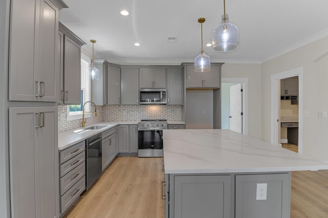 11555 New Cut Rd, Campobello, SC 29322 - kitchen with gray cabinets, stainless steel appliances, a kitchen island, light wood-style floors, and ornamental molding